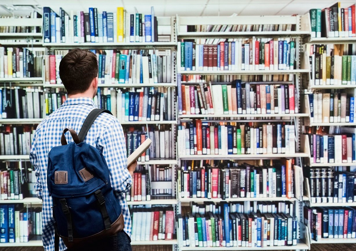 Бесплатные библиотеки для студентов. Студенты в библиотеке. Люди в библиотеке. Студент с книгами. Читатели в библиотеке.